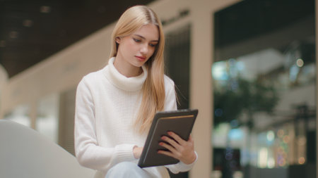 Caucasian woman girl manager working in office professional businesswoman use digital tablet surfing web looking at device screen female employer executive ceo student studying online e-business appの写真素材