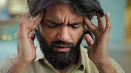 Arabian Muslim unhappy bearded man unhealthy guy businessman stressful executive massaging temples...