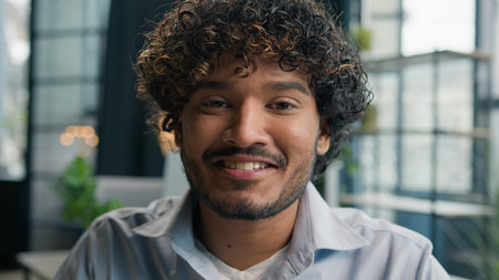 Head shot portrait Latino hispanic businessman Arabian Indian guy looking at camera happy smiling...