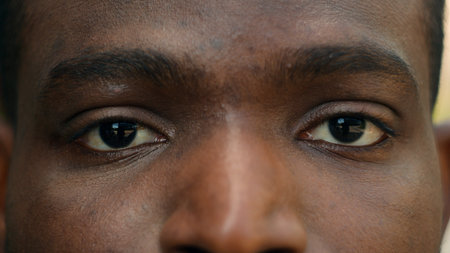 Close up cropped view detail ad male African American ethnic dark eyes close open blink ophthalmology eyesight see look vision sight eye problem strain ill sick facial expression looking laser surgeryの写真素材