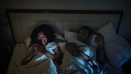 African American couple family in bed bedroom night angry frustrated man husband trying sleep...