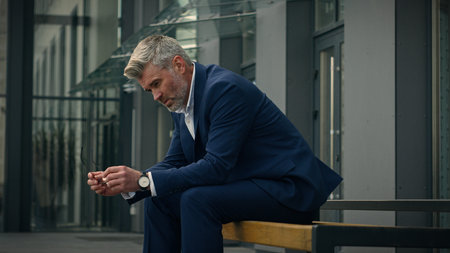 Sad upset worried employer pondering thoughtful leader unemployment frustrated stress pensive senior business man sorrowful think relax old mature businessman problem solution thinking tired in cityの写真素材