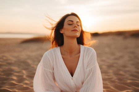Portrait gorgeous charming relaxed European woman lady girl female sitting performing meditation beach sand ocean sea. Vacation trip mental health care happy traveler holiday soul rest wellness yogaの素材