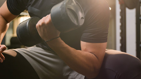 Close up moving shot strong athletic African American ethnic man guy in gym doing sport exercise...