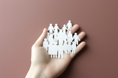 Hand holding paper figures happy family bond concept children health insurance together parents care for child protection safety security community partners silhouette love symbol help cooperationの素材