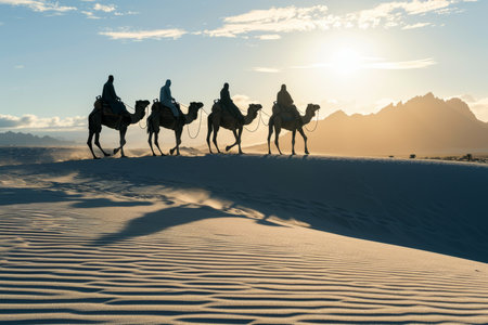 Silhouette people riding camels in desert native tuareg arabic african person Sahara wildlife tourist attraction Dubai arab tour sunset caravan adventure long journey tour dune sun Bible story Quranの素材