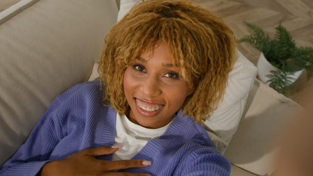 Web cam view smiling happy African American ethnic girl woman waving hand greeting talking online...