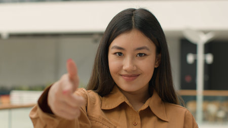 Asian woman happy joyful girl point finger at camera hey you gesture chinese korean japanese businesswoman employer leader saleswoman smiling lady female HR manager of business company looking smileの写真素材
