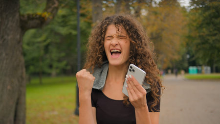 Happy amazed excited surprised woman Caucasian girl hold mobile phone reading news win celebrate...