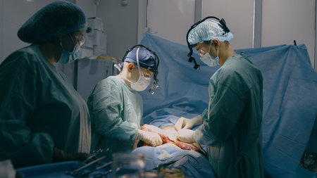 Professional surgeons doctors with assisting nurse perform surgical operation intensive therapy...