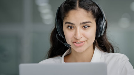 Close-up young woman assistant sales agent advisor hotline consultant answering incoming call using...