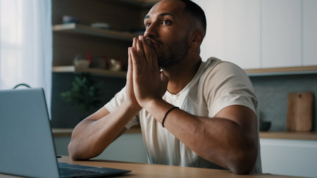 African Latina male man at kitchen at home play online game bet losing betting bad result feel...