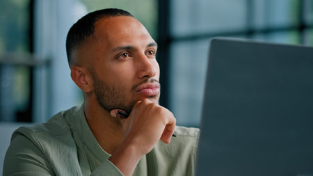 Closeup pensive thoughtful African Latina man manager writer journalist specialist entrepreneur...