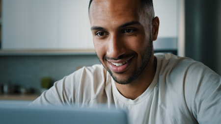 Close up front view African multiethnic man guy indoors using laptop typing chatting browsing with computer at home working remote play online game internet app shopping e-commerce website distant jobの写真素材