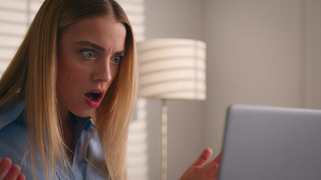 Close up angry upset Caucasian woman user using laptop in home office frustrated mad confused...