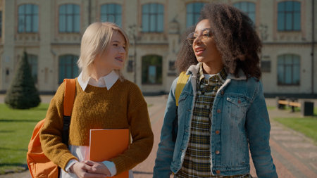 Two multiracial people women students girls multiethnic diversity friends classmates Caucasian girl...