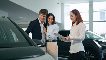Caucasian couple buyers clients talking with woman dealer saleswoman salon showroom rental service...