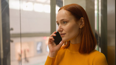 Smiling Caucasian business woman girl businesswoman female customer consumer client riding elevator...