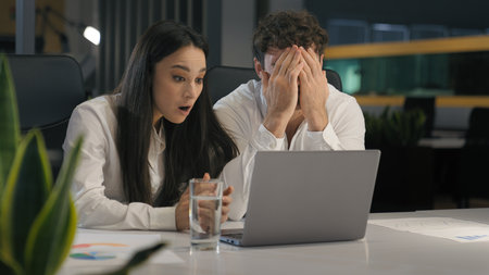 Business coworkers colleagues partners office workers businesswoman businessman Caucasian man woman with laptop hope success sad upset shock with online failure financial crisis crash market websiteの写真素材