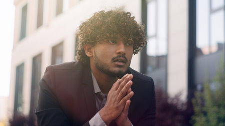 Suffering stressful bad feeling thinking anxious worried irritated Indian business man suffer with illness painful headache think frustrated problem businessman employer entrepreneur in city outdoorsの写真素材