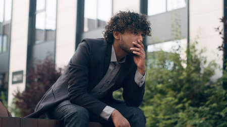 Suffering anxious worried irritated business man feeling bad headache frustrated problem businessman employer manager entrepreneur in city outdoors thinking about corporate trouble headacheの写真素材