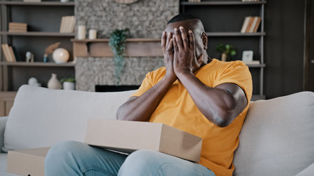 Surprised african adult man unpack parcel box american bachelor homeowner consumer birthday person...