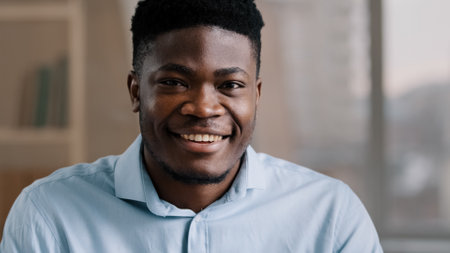 Portrait of successful handsome African American businessman male 30s ethnic boss ceo freelancer customer brunet adult man guy dreaming turns head looking at camera smiling toothy white healthy smileの写真素材