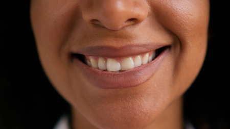 Close up lips African American woman female facial expression positive toothy dental smile mouth...