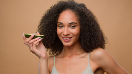 African American beautiful happy smiling pretty woman girl female model with curly hair at studio...