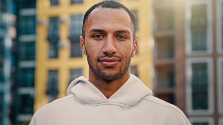 Portrait satisfied attractive man give positive recommendation make thumb up gesture approved symbol of good choice recommend sport and healthy lifestyle happy sportsman stand on cityscape backgroundの写真素材