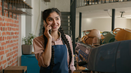 woman waitress barista in apron wipe dust using cleaning duster smiling female girl cleaner bar employee wiping washing shelf with spices in cafe restaurant clean shelves in cafeteriaの写真素材