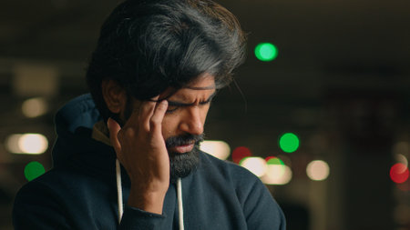 Close up stressed ill worried bad feeling unwell bearded Indian man take off glasses message head temples eyes pain headache pain discomfort stress Arabian sad businessman guy suffer grief migraineの写真素材