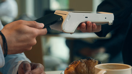 Close up hands visitor man pay bill food order in cafe restaurant unrecognizable waiter holding terminal wifi scan using smartphone contactless NFC payment cashless client service mobile phone bankの写真素材