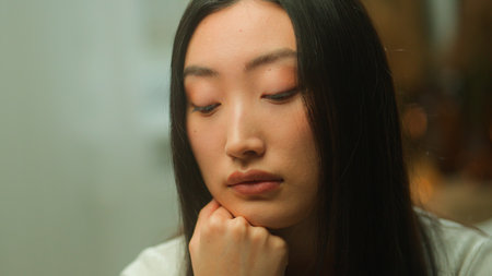 Asian chinese korean disappointed sad woman girl lonely japanese lady female girlfriend upset thoughtful looking down think difficult trouble sorrowful worried depression sick health problem medicineの写真素材