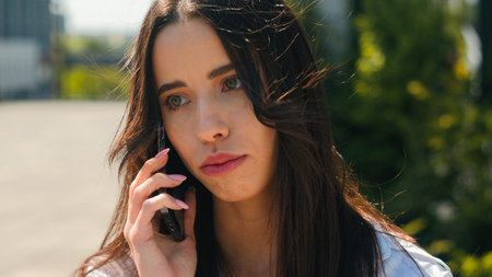 Close-up upset frustrated arabian woman talking on mobile phone outdoors receive bad news worried...