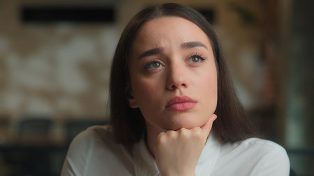 Thoughtful pensive puzzled girl Caucasian business woman student university study difficult task exam write notes think ideas office desk writing notebook female businesswoman thinking analyze ponderの写真素材