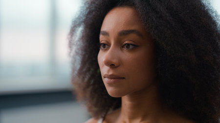 Beautiful girl female moisturized smooth healthy good skin tone applying powder blush make-up matte cosmetic prepare beauty skincare procedure pretty attractive African American woman powdering faceの写真素材