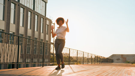 Female silhouette in sunshine city urban active playful happy girl African American business woman...