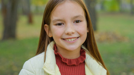 Close up portrait in park autumn alone one beautiful adorable adopted cute teen schoolgirl smiling...