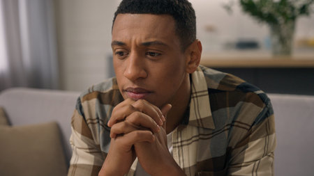 African American man upset think concern job loss at home stress cancer patient worry health problem ethnic guy thinking male trouble crisis bad news pensive sad regret depressed mental heartbreakの写真素材