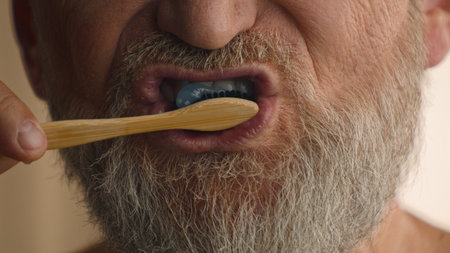 Close up unrecognizable old male retired middle-aged senior mature elderly man cropped view mouth brushing teeth toothbrush and toothpaste morning hygiene procedure oral anti cavity tooth care dentalの写真素材