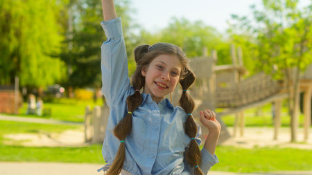 Caucasian child teenager female little girl daughter schoolgirl gen z school pupil dancing in park outdoors playful joyful kid dancing happy childhood funny dance family adopt custody holiday in cityの写真素材