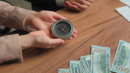 Multiracial office partners Arabian businessman businesswoman male female man muslim woman in hijab hold compass business direction investment stock market financial navigation search money successの写真素材