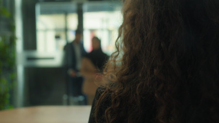 Back view concierge meet couple tourists guests hello welcome hotel reception muslim man woman travelers travel arrive visit resort journey vacation administrator check passports booking room serviceの写真素材