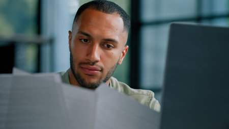 Serious pensive thinking African Latina businessman boss auditor checking corporate paperwork...