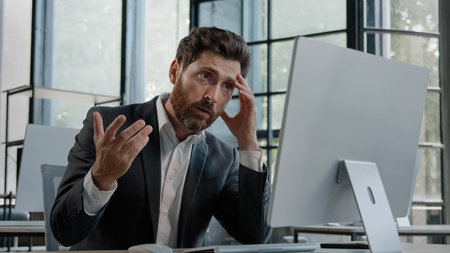 Caucasian 40s bearded boss investor entrepreneur employer man in office with computer working typing...