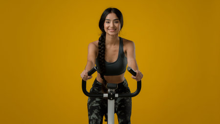 Indian slim happy smiling sporty woman female lady athletic girl cyclist biking flexing cycling...