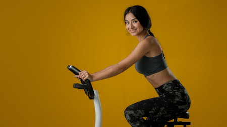 Indian ethnic strong slim sporty woman female lady athletic girl biking flexing cycling on exercise...