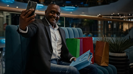 Middle-aged male African American man buyer client customer blogger influencer vlogger with shopping...