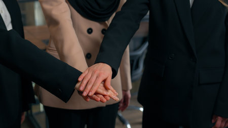 Multiracial women business colleagues three multiethnic businesswomen girls Caucasian Asian Muslim ladies ethnic different unite happy office team stack female hands together partnership collaborationの写真素材